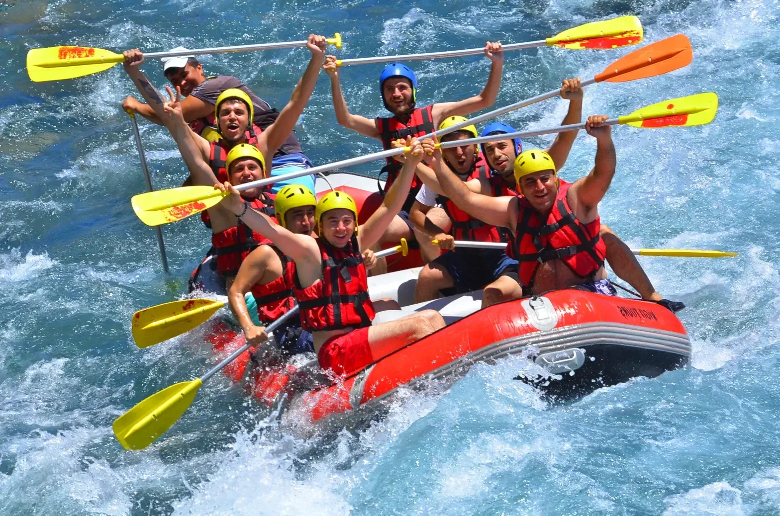 Raft hitting the rapids on the turquoise river
