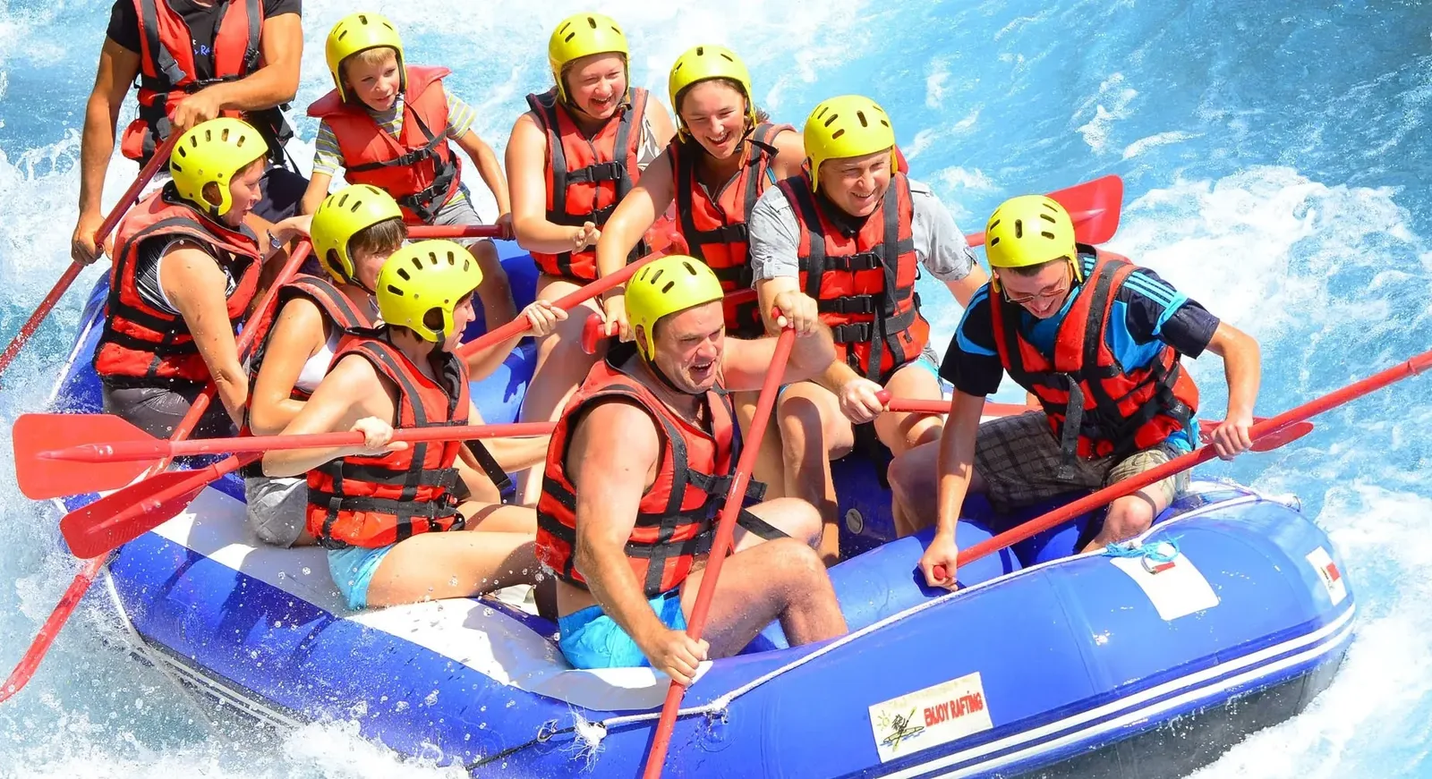 Blue raft with families and children aboard